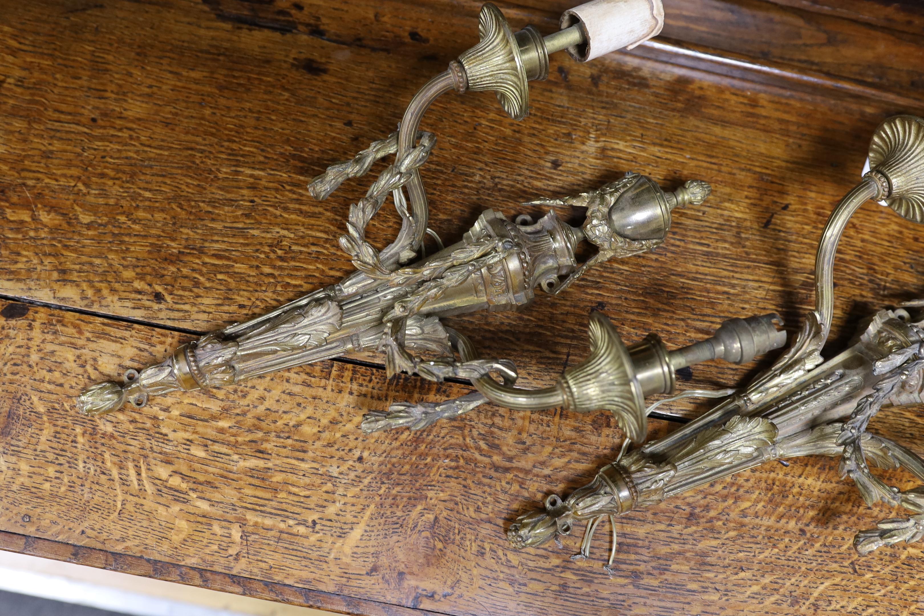 A pair of Louis XVI style bronze two branch swagged wall sconces, 39cm high